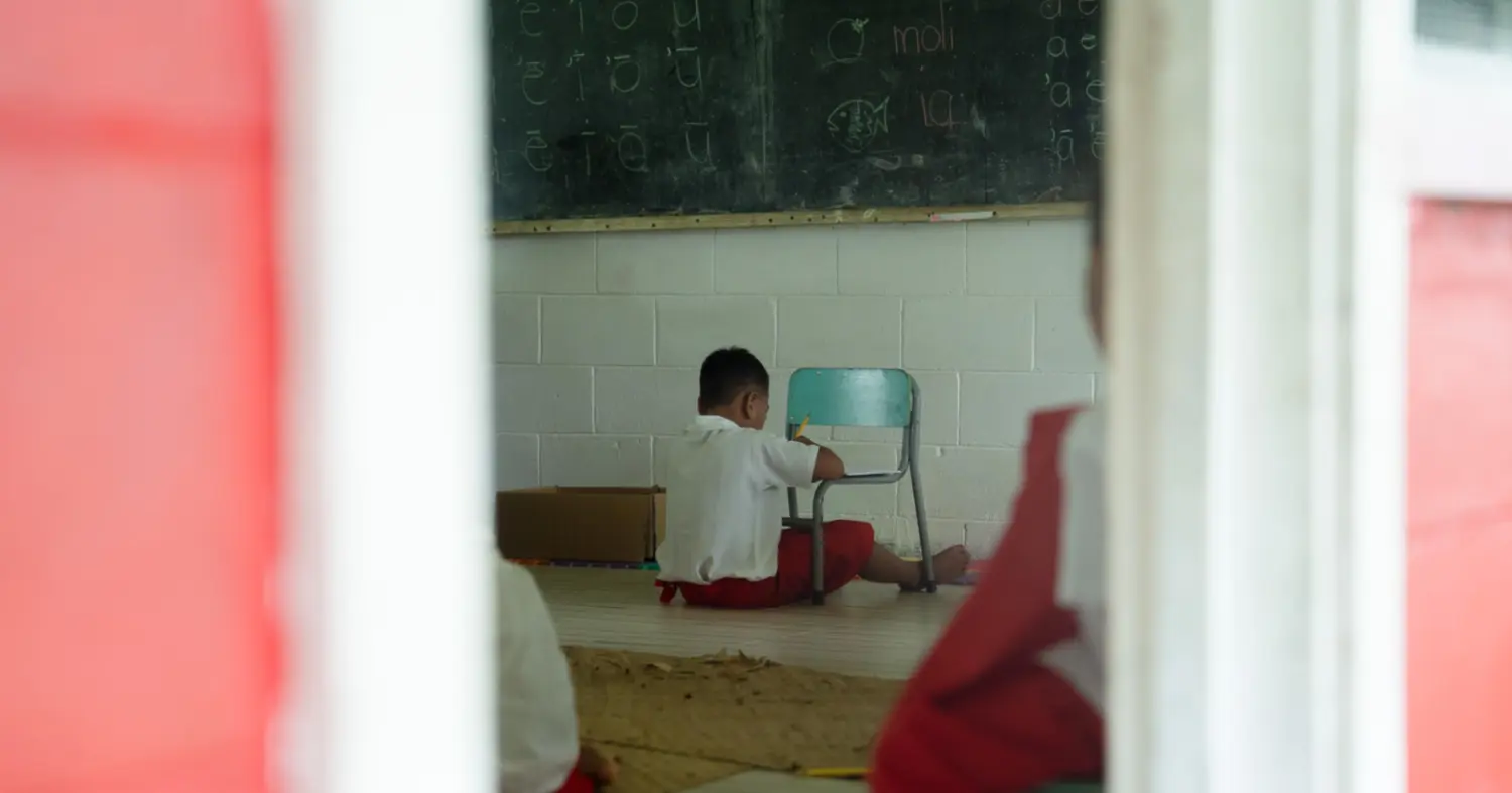 Students sitting on floors, school calls for assistance