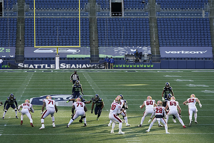 The Latest: Seahawks to continue playing in empty stadium