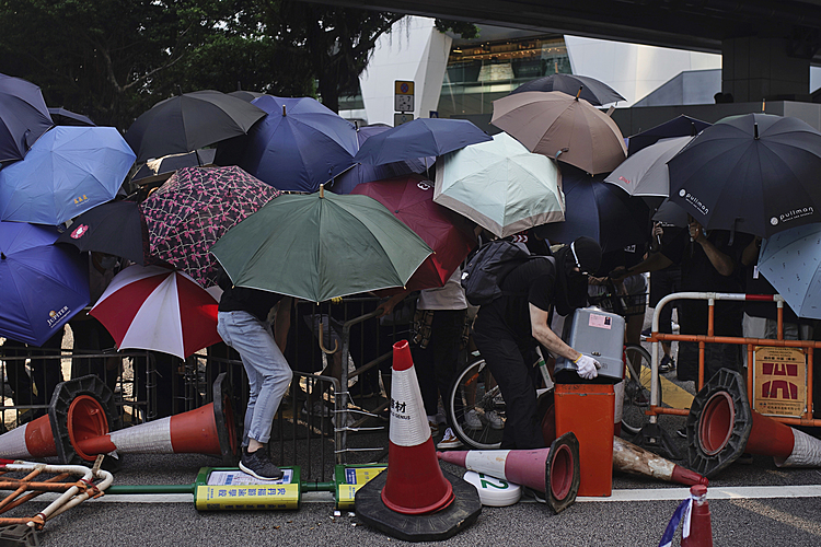 Thousands protest mask ban as HK leader toughens stance