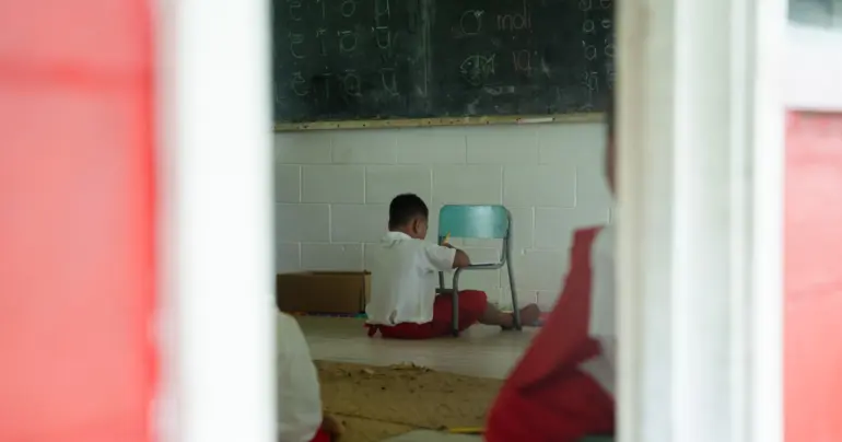 Students sitting on floors, school calls for assistance