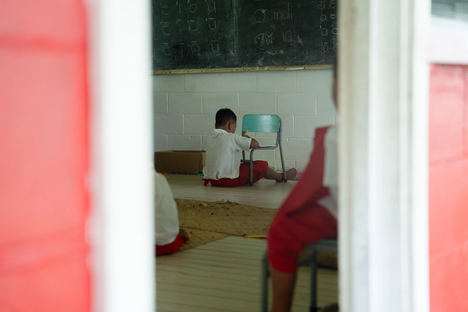 Students sitting on floors, school calls for assistance