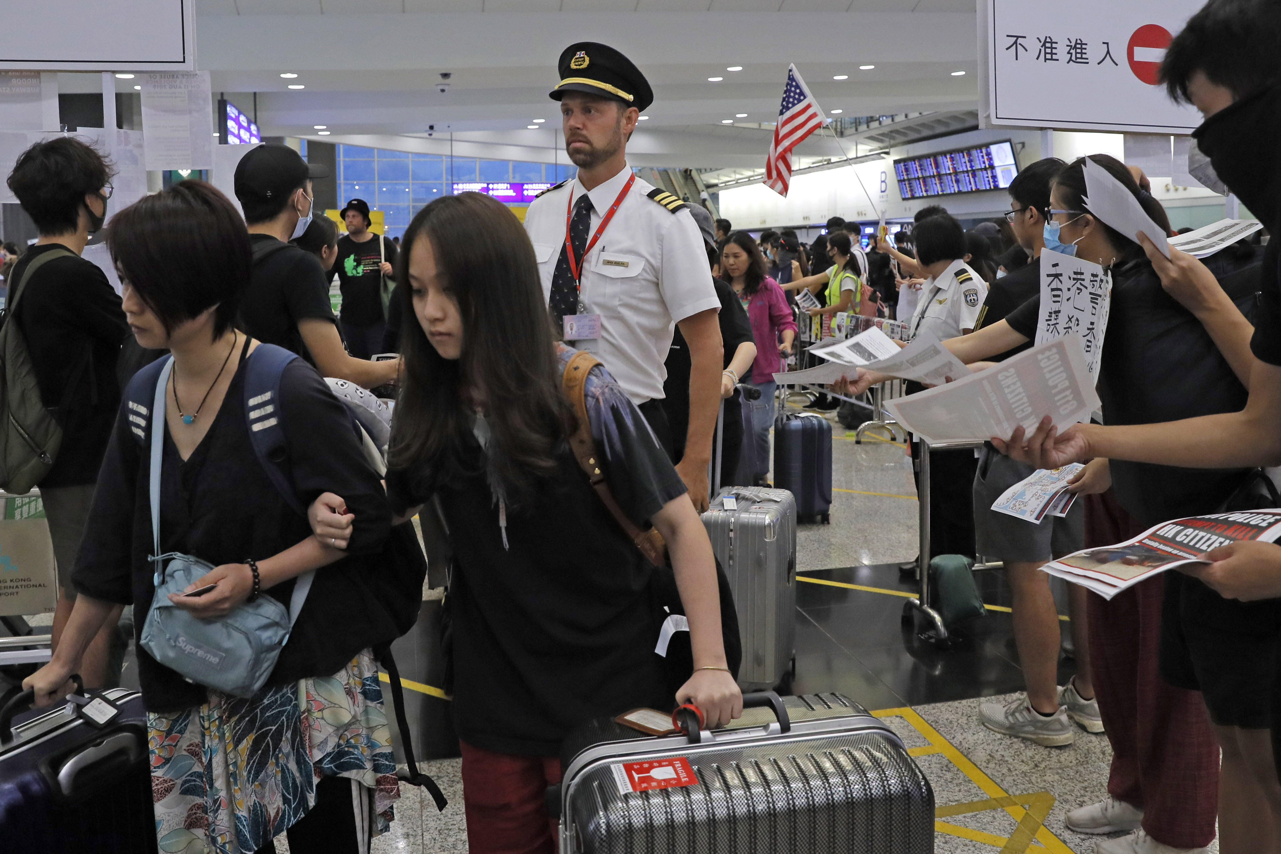 The Latest: Hong Kong flights take off as protesters return