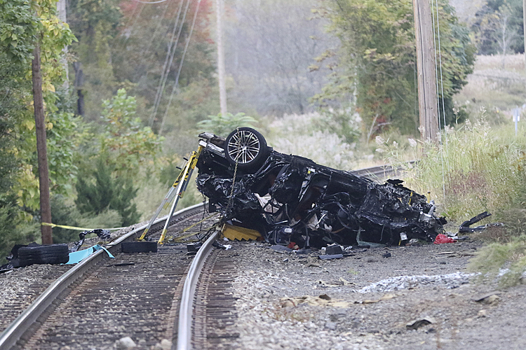 Porsche SUV plunges onto train tracks, burns; 2 teens die