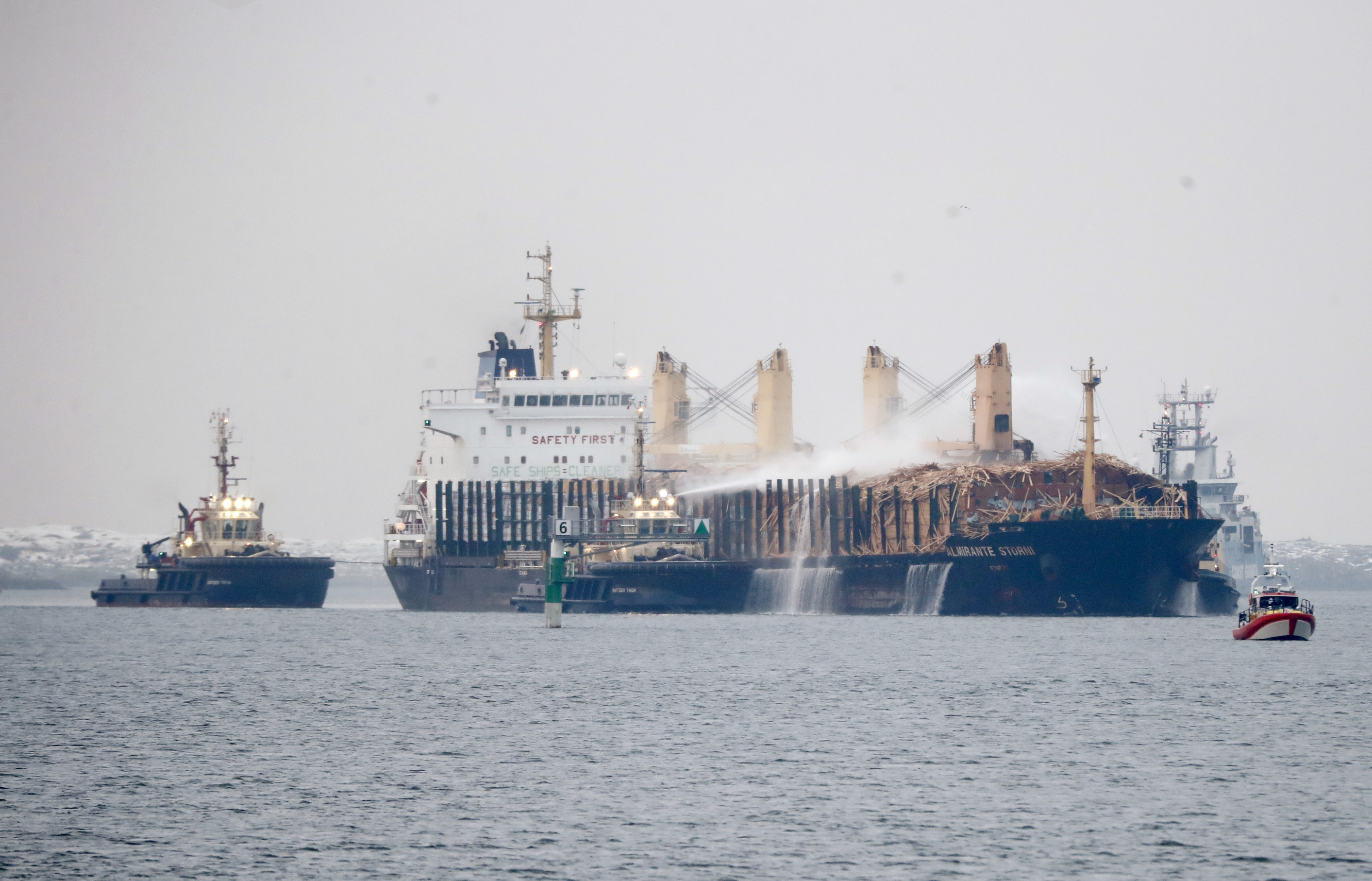 German ship with burning timber cargo towed to Swedish port