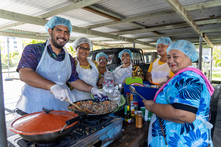 Fish vendors in tuna processing workshop