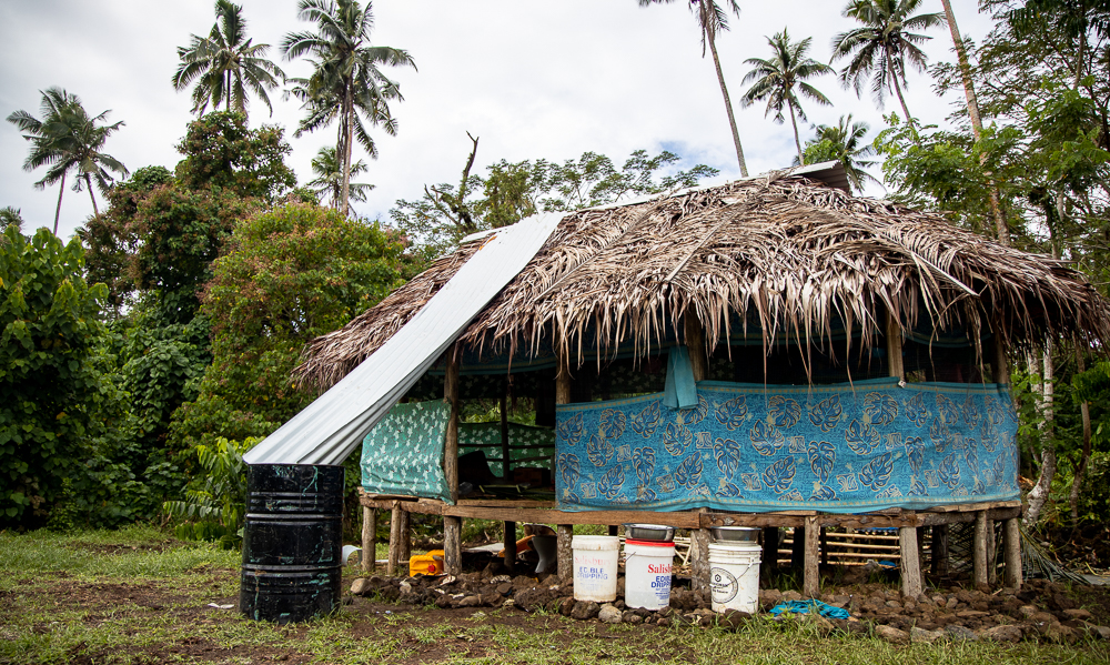 Splintered family huddles under thatched roof, shared dream