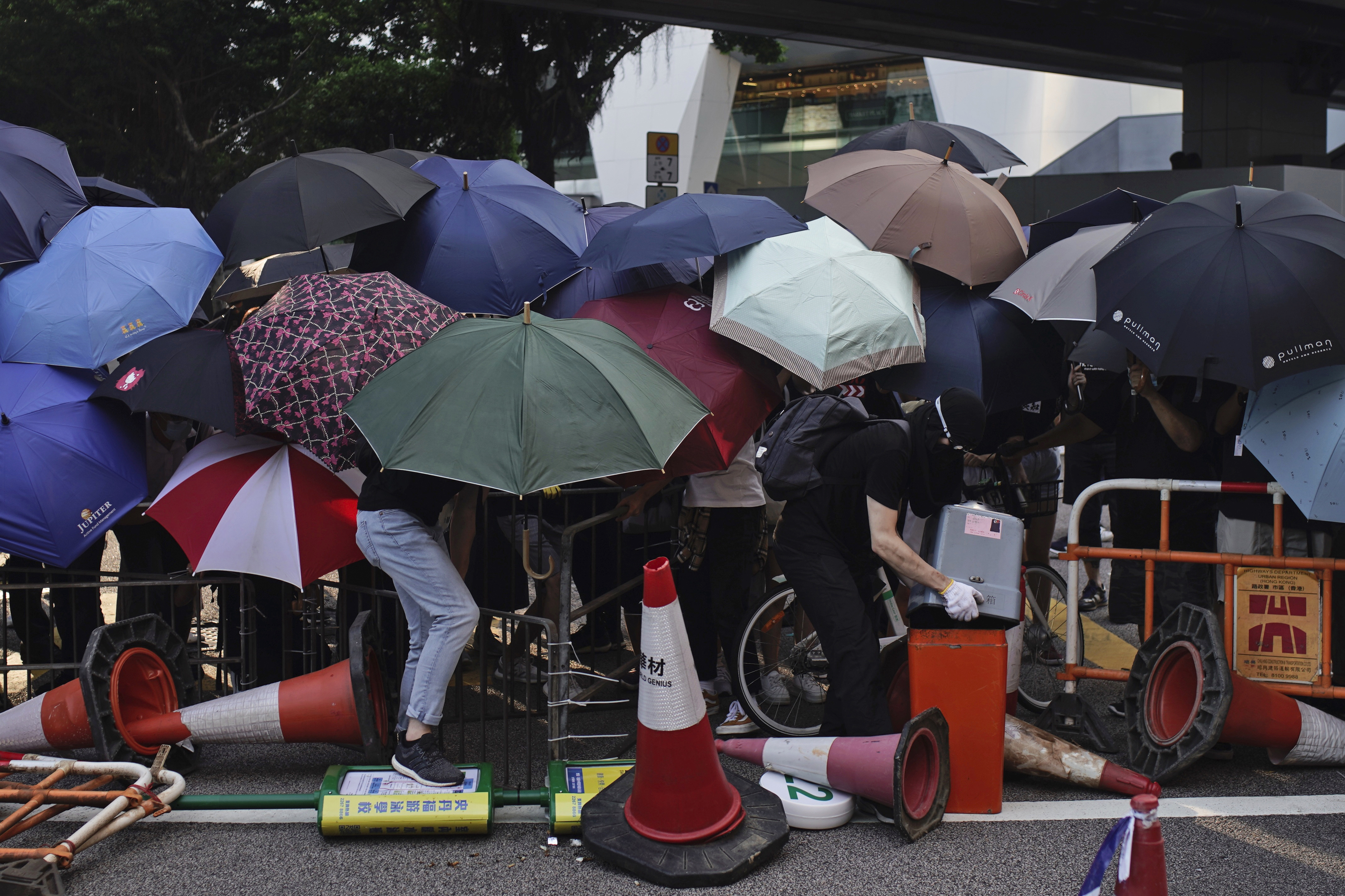 Thousands protest mask ban as HK leader toughens stance
