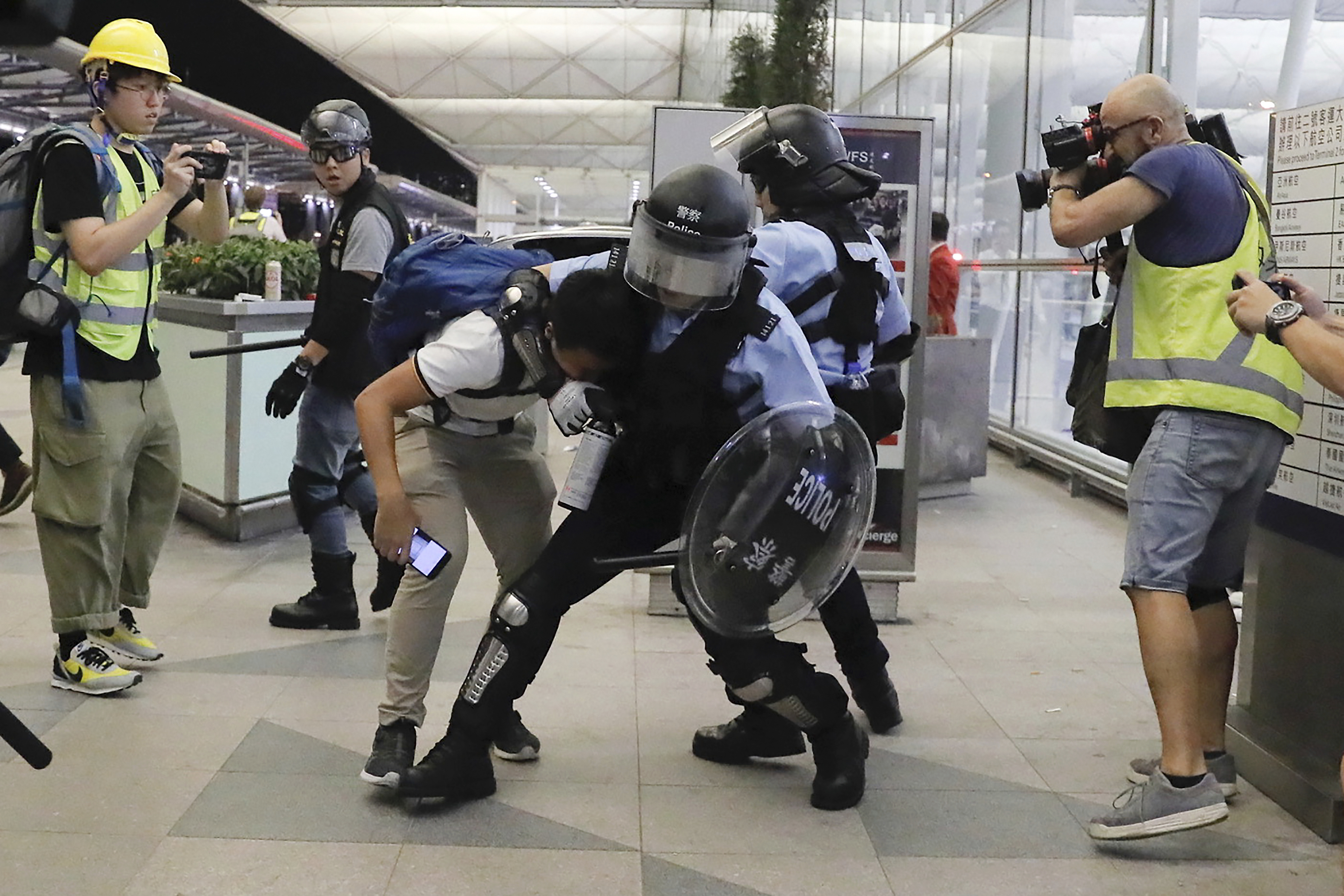 Riot police, protesters clash briefly at Hong Kong airport