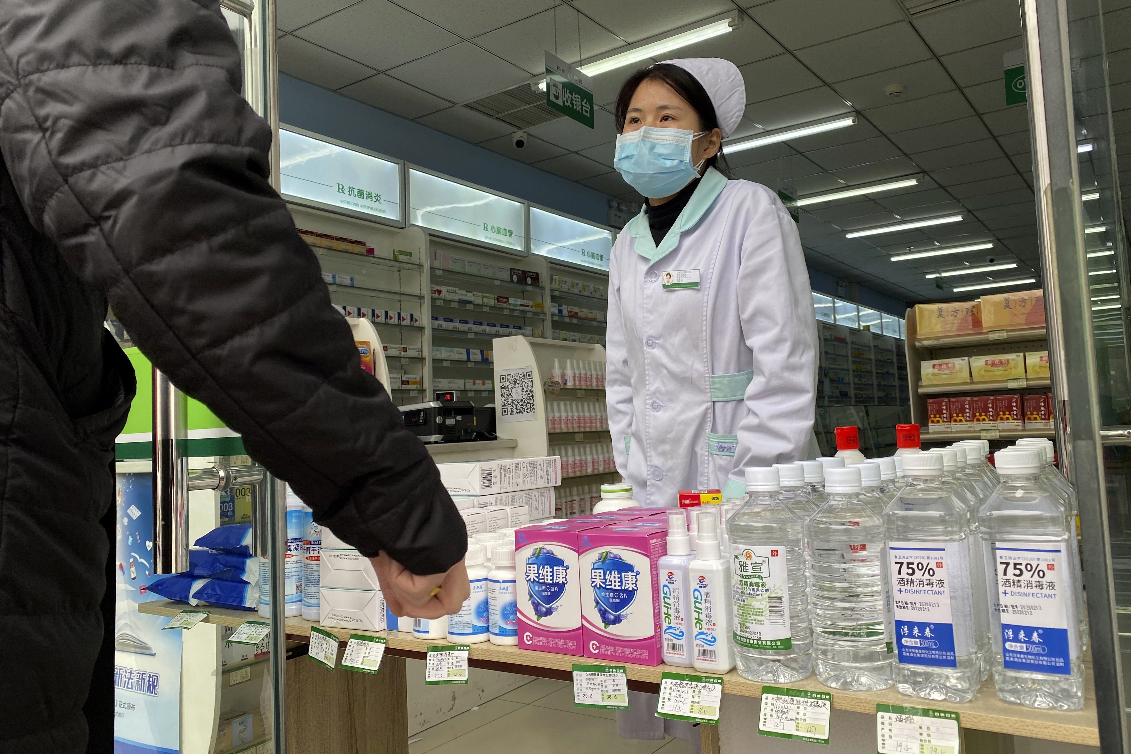China's virus cases, deaths rise, but count revised again

