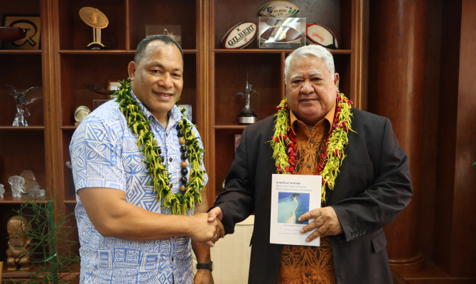P.M. presented with copy of "In the Eye of the Storm"