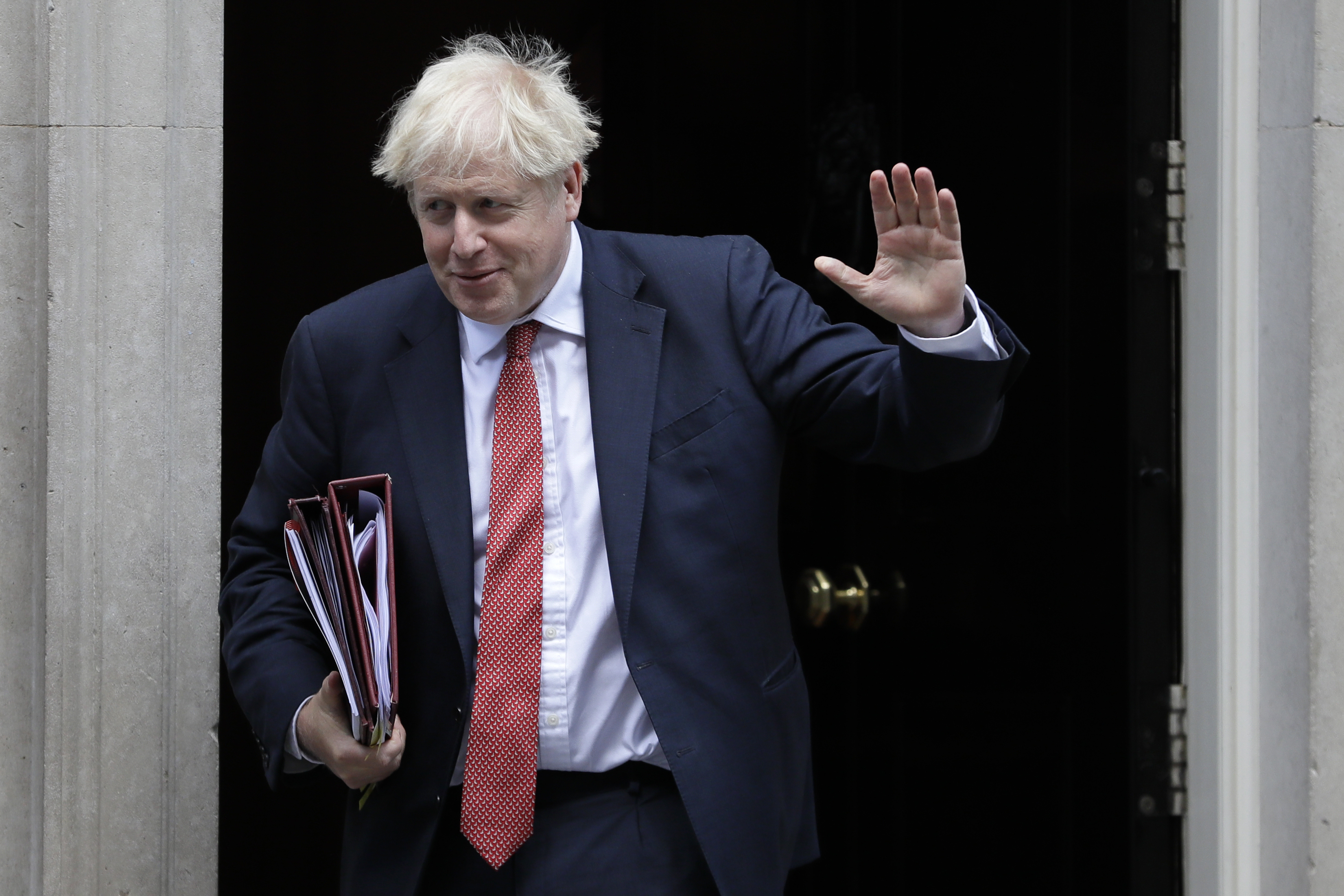 The Latest: Britain PM resists calls to extend worker wages 
