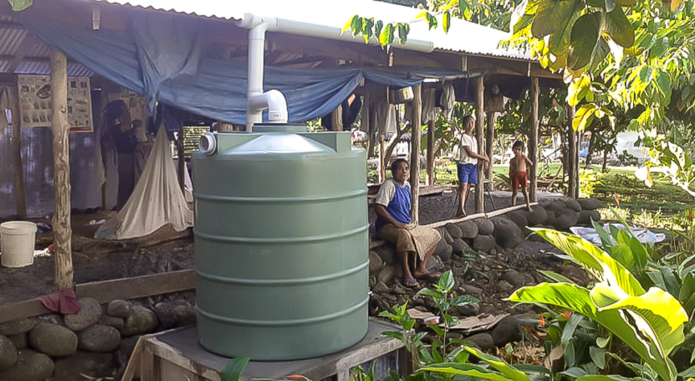 Two families receive water tanks