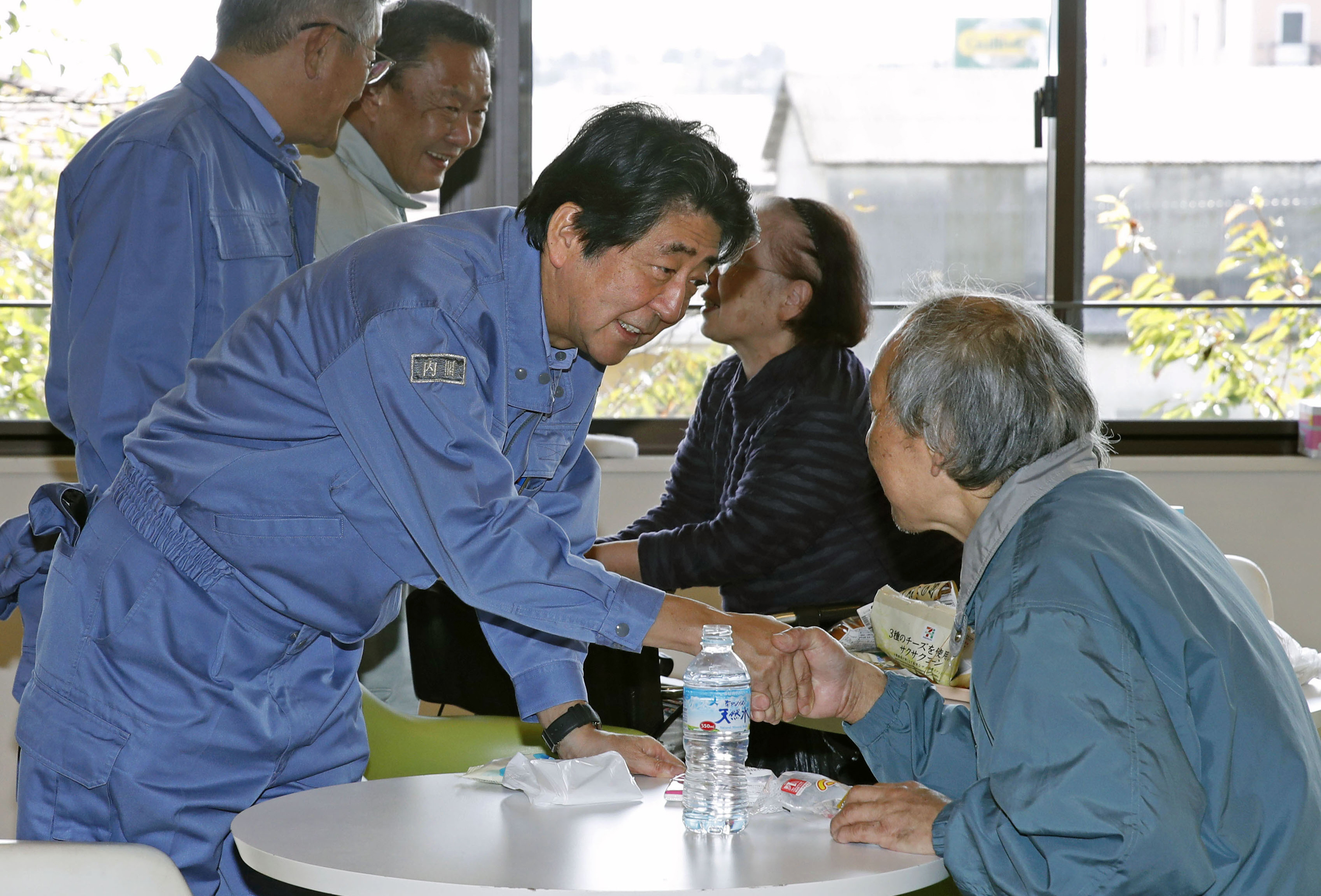 Japan PM visits storm-hit areas, royal parade may be delayed