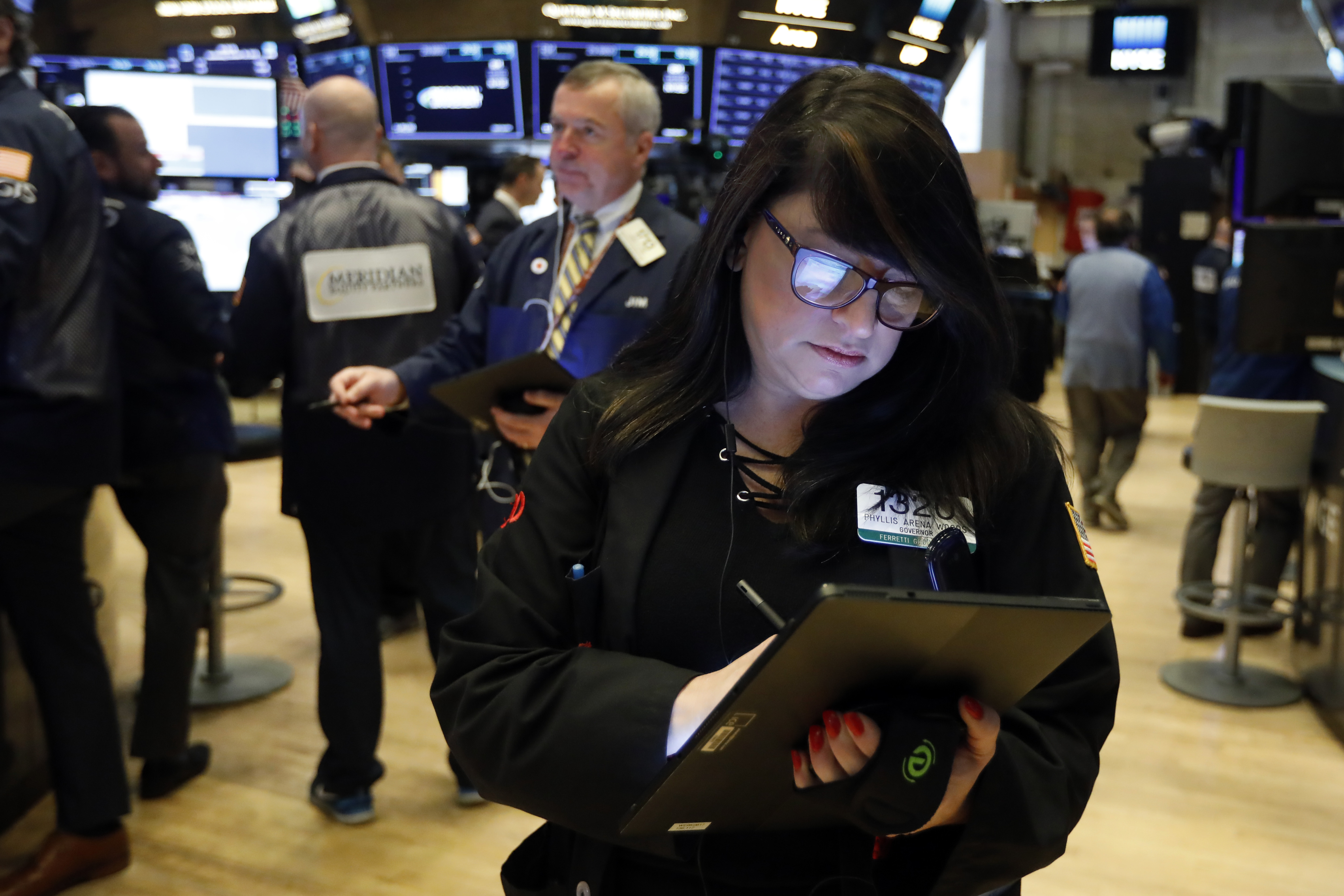 Stocks wobble in midday trading, but stay near record highs