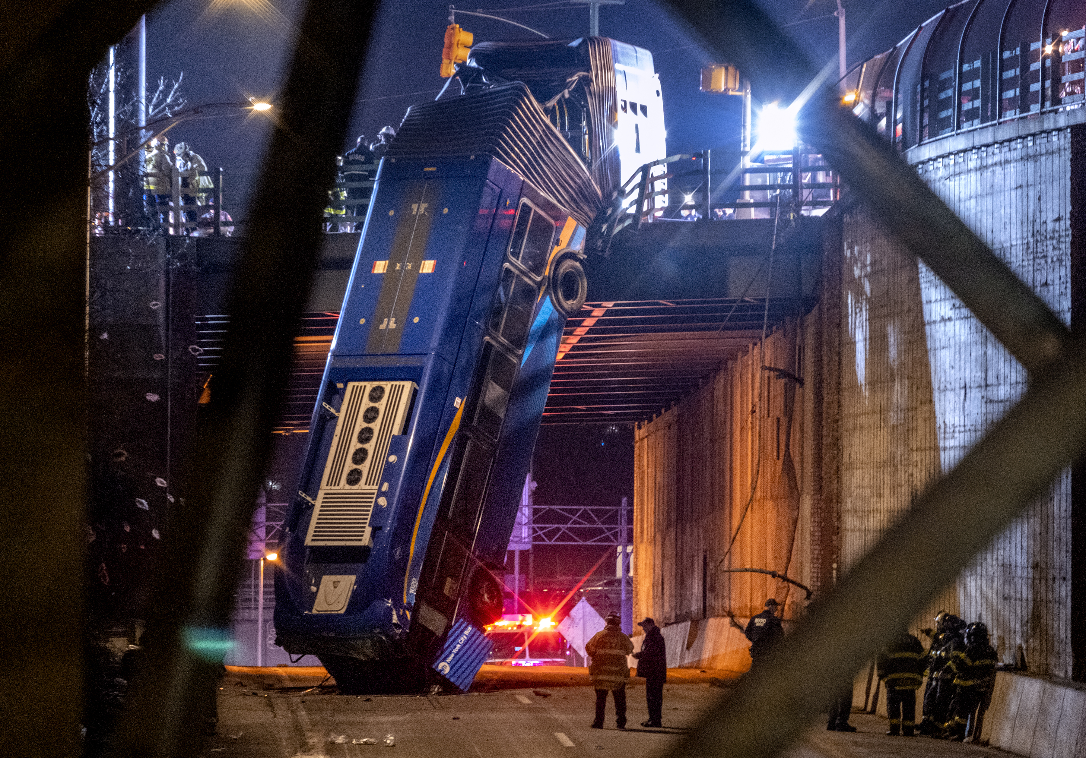 New York City bus left dangling from overpass after crash